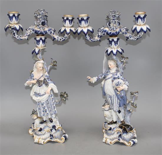 A pair of Meissen porcelain candelabra, modelled with lady and gallant stems, height 46cm